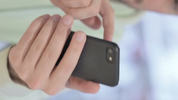 Vertical Video Young Adult Man Browsing Internet Smartphone — Vídeo de Stock