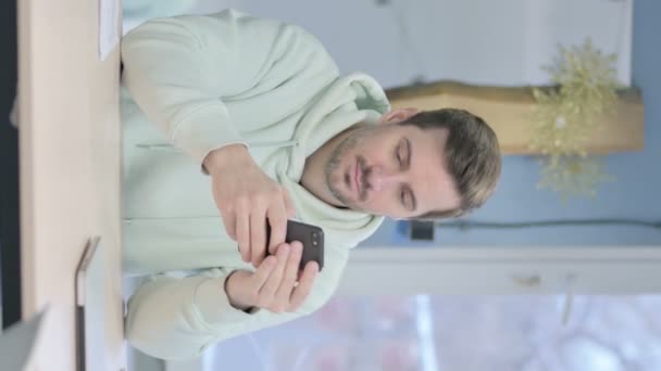 Vertical Video Young Adult Man Browsing Internet Smartphone — Vídeos de Stock