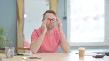 Tired Young Adult Man with Headache at Work, Migraine