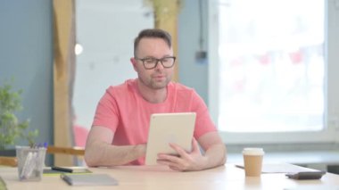 Young Adult Man using Digital Tablet, Browsing Internet
