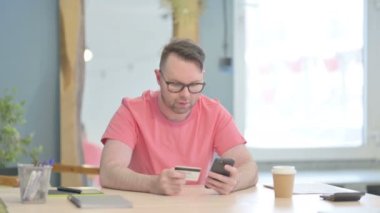 Young Adult Man making Successful Online Payment on Smartphone
