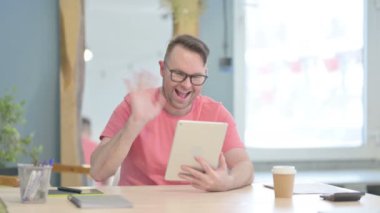 Online Video Chat on Tablet by Young Adult Man