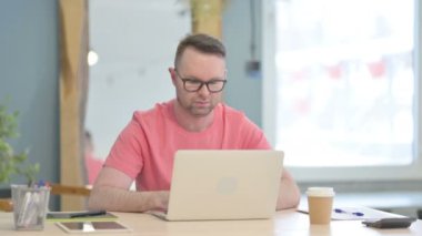 Young Adult Man having Wrist Pain while using Laptop