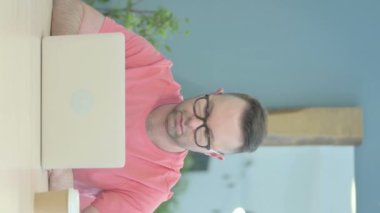 Vertical Video of Senior Old Man Typing on Laptop