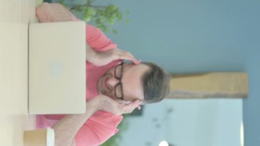 Vertical Video of Senior Old Man with Headache at Work