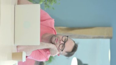 Vertical Video of Senior Old Man Sleeping at Work