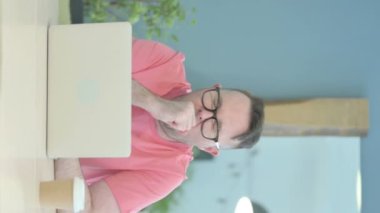 Vertical Video of Senior Old Man Coughing ate Work
