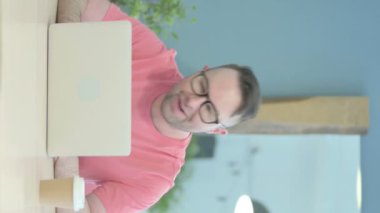 Vertical Video of Senior Old Man Doing Online Video Chat on Laptop