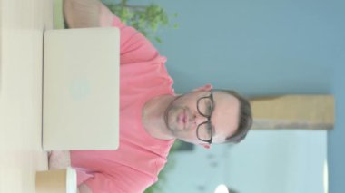 Vertical Video of Thumbs Up by Senior Old Man Working on Laptop