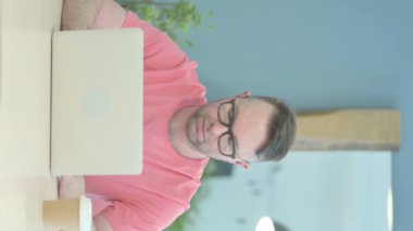 Vertical Video of Rejecting Senior Old Man Shaking Head at Work