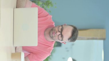 Vertical Video of Shocked Senior Old Man Looking at Camera at Work