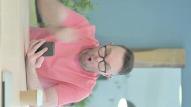 Vertical Video of Senior Old Man Celebrating Success on Smartphone