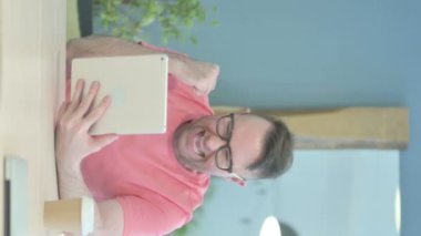 Vertical Video of Senior Old Man Cheering Success on Tablet