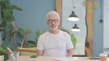 Senior Old Man showing Thumbs Up at Work