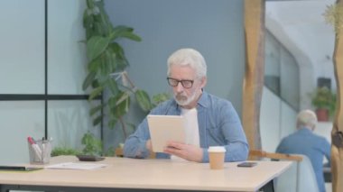 Senior Old Man Using Tablet for Browsing Internet