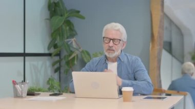 Online Video Chat by Senior Old Man at Work