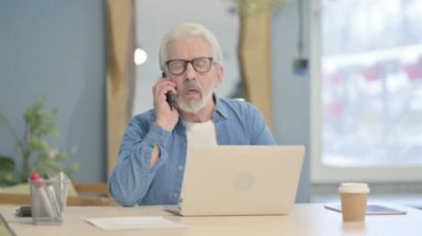 Displeased Senior Old Man Talking on Phone