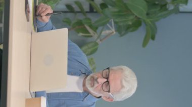 Vertical Video of Male Graphic Designer Working on Laptop and Graphic Tablet