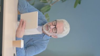 Vertical Video of Senior Old Man Talking for Online Video Chat via Tablet Computer