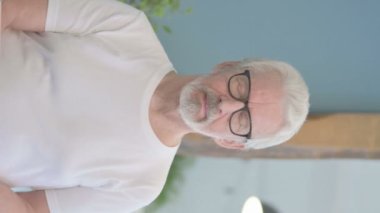 Vertical Video of Serious Senior Old Man Looking at the Camera