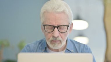 Close Up of Senior Old Man Typing on Laptop in Office