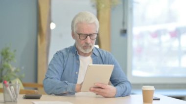 Senior Old Man Celebrating Online Success on Tablet