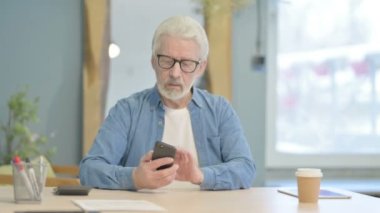 Senior Old Man Talking on Phone in Office