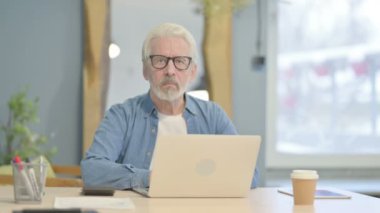 Thumbs Down by Senior Old Man in Office