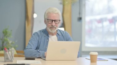Senior Old Man Showing Thumbs Up while Working on Laptop