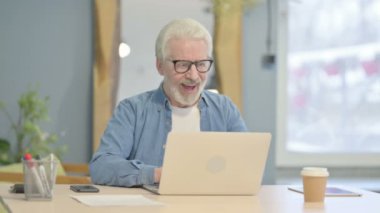 Senior Old Man Celebrating Online Success on Laptop
