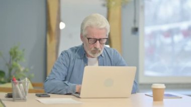 Senior Old Man with Headache Working on Laptop