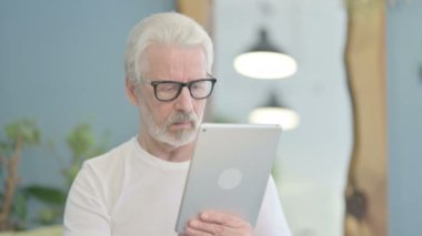 Portrait of Senior Old Man Working on Digital Tablet