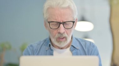 Close Up of Senior Old Man Coughing and Working on Laptop