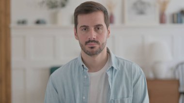 Portrait of Serious Casual Man Looking at the Camera