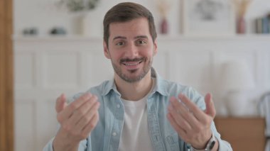 Portrait of Casual Man Pointing at the Camera and Inviting