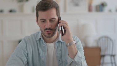 Casual Man Talking on Phone, Discussing Work