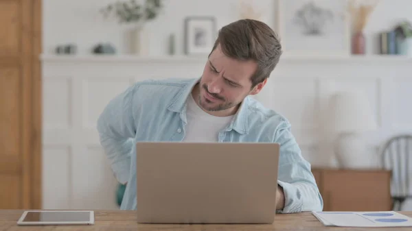 Casual Man Having Back Pain While Using Laptop — Stockfoto