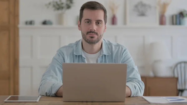 Casual Man Looking Camera While Using Laptop — Photo