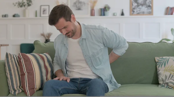 Casual Man Having Neck Pain While Sitting Sofa — Stock fotografie