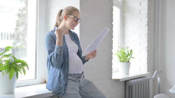 Cheering Pregnant Beautiful Woman Excited after Reading Documents