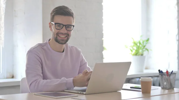 Young Adult Man Smiling Camera While Using Laptop — Stock Photo, Image