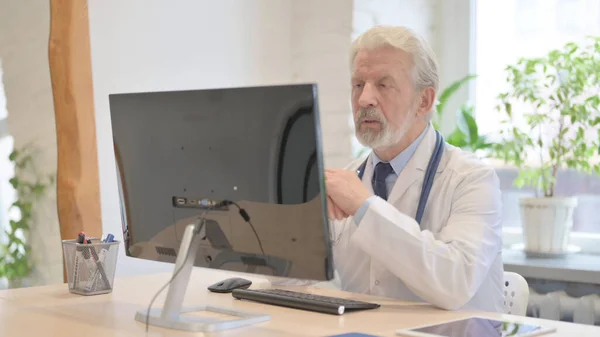 The Old Doctor Talking on Video Call on Computer in Clinic