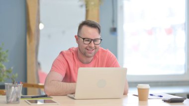 Young Adult Man Doing Online Video Chat in Office