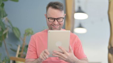 Young Adult Man Doing Online Video Chat on Tablet