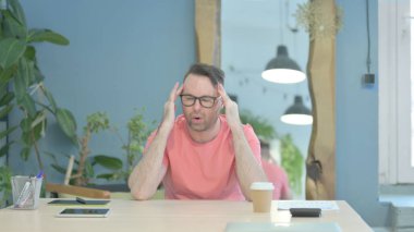 Tired Creative Senior Old Man with Headache at Work, Migraine