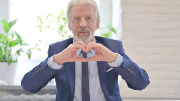 Loving Old Businessman Showing Heart Shape Hands — Stockfoto