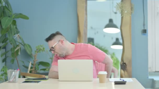 Creative Adult Man Having Back Pain While Using Laptop — стоковое видео