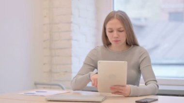 Creative Young Woman Shocked by Loss on Digital Tablet