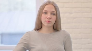 Portrait of Creative Young Woman showing Thumbs Down