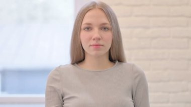 Young Woman Asking for Silence With Fingers on Lips, Quiet Please